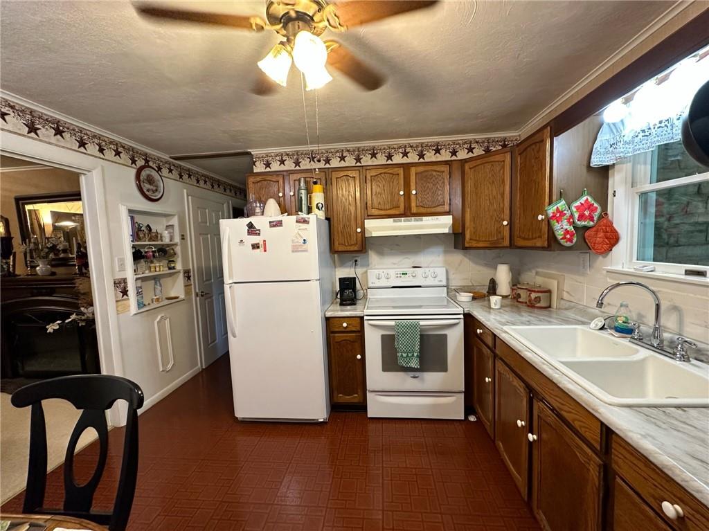 696 Leighty Hollow Road Ruffs Dale, PA 15679 - Photo 18 of 46 a kitchen with a sink dishwasher a refrigerator and a stove