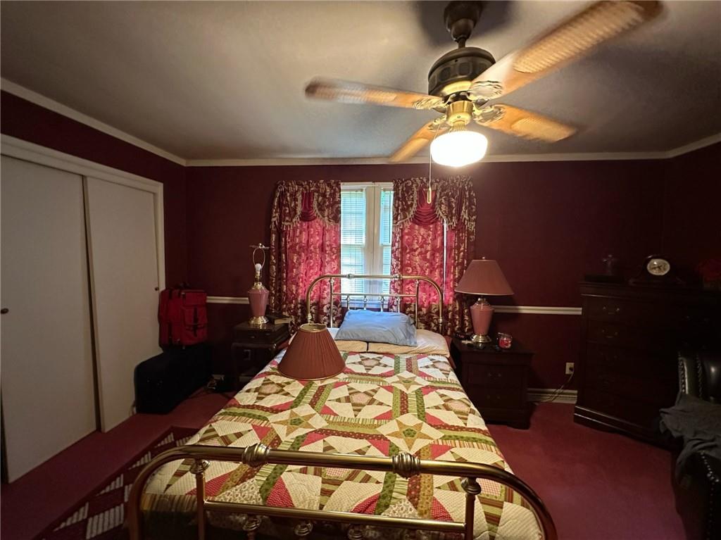 696 Leighty Hollow Road Ruffs Dale, PA 15679 - Photo 22 of 46 a bedroom with a bed and a chandelier