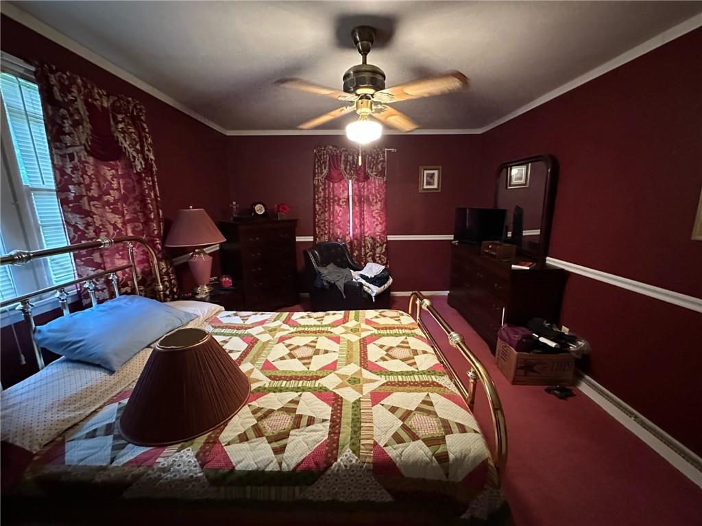 696 Leighty Hollow Road Ruffs Dale, PA 15679 - Photo 23 of 46 a bed sitting in a bedroom next to a lamp