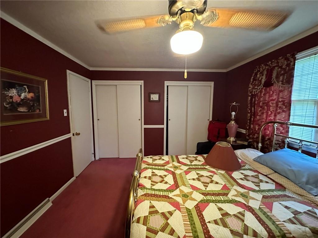 696 Leighty Hollow Road Ruffs Dale, PA 15679 - Photo 24 of 46 a bedroom with a bed and a chandelier