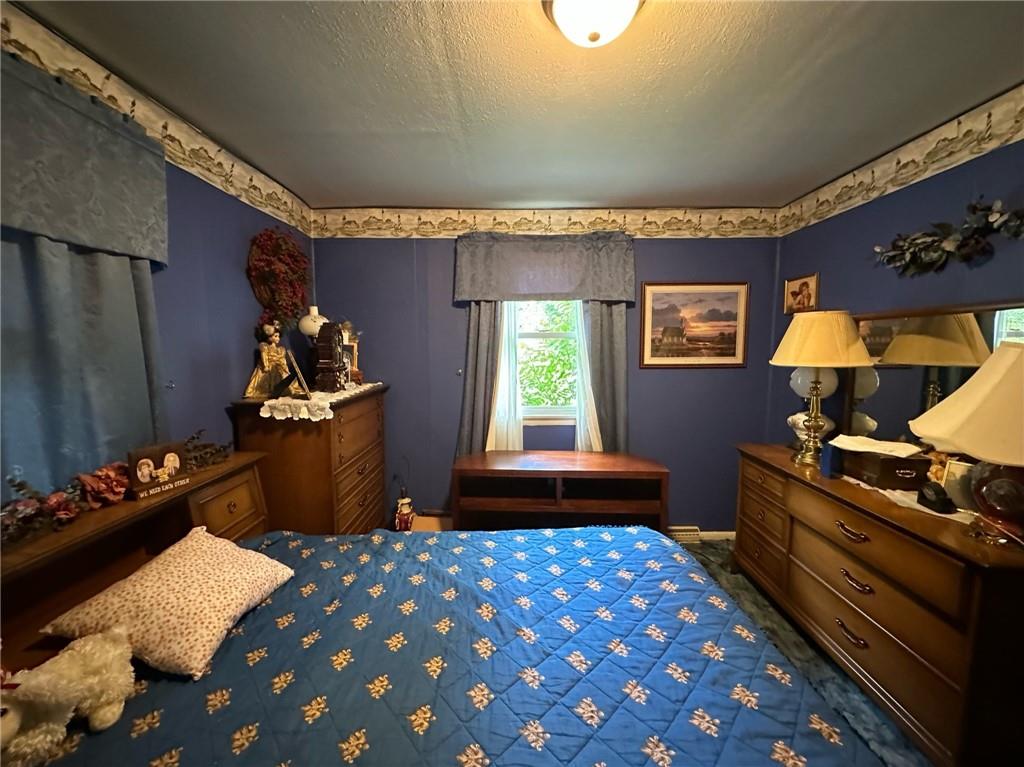 696 Leighty Hollow Road Ruffs Dale, PA 15679 - Photo 26 of 46 a bedroom with furniture and a window
