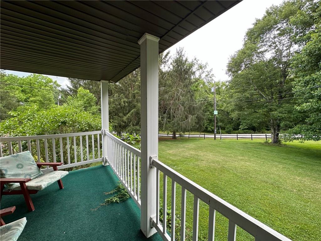 696 Leighty Hollow Road Ruffs Dale, PA 15679 - Photo 7 of 46 a view of a deck with a floor to ceiling window and a yard