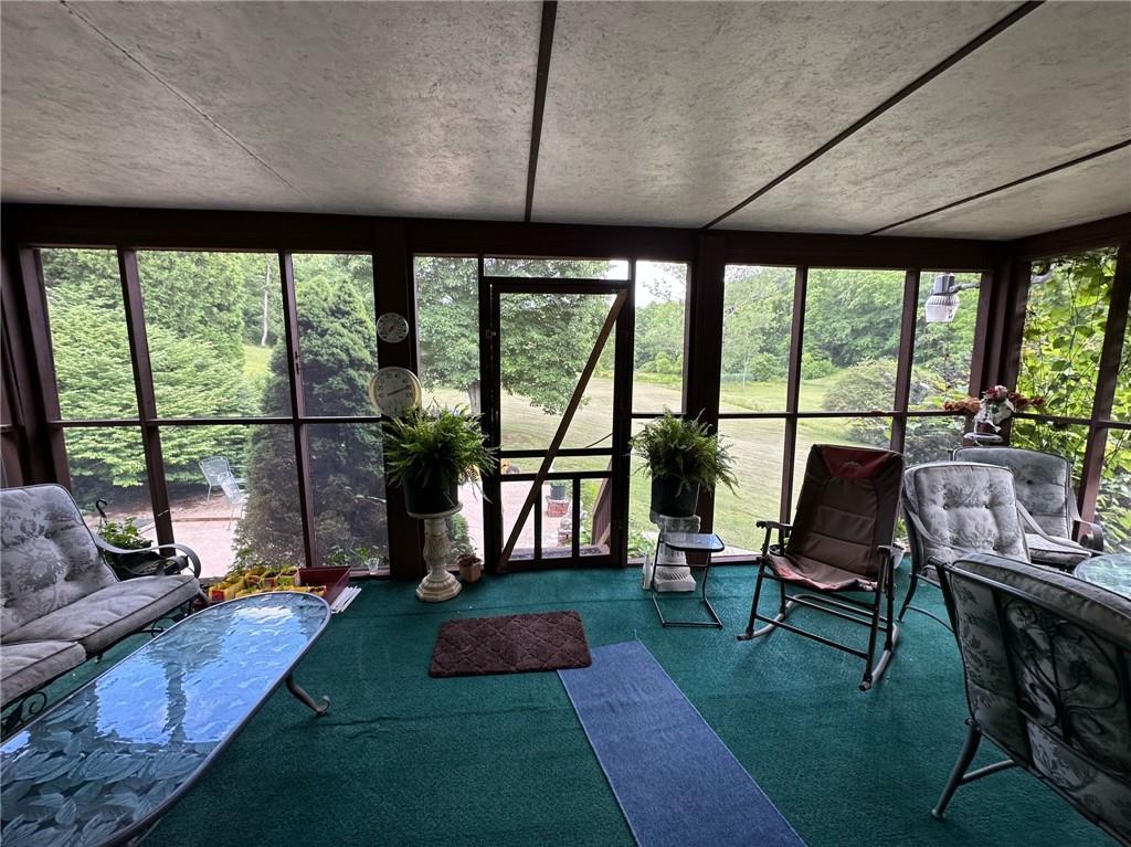696 Leighty Hollow Road Ruffs Dale, PA 15679 - Photo 9 of 46 a living room with furniture and a floor to ceiling window