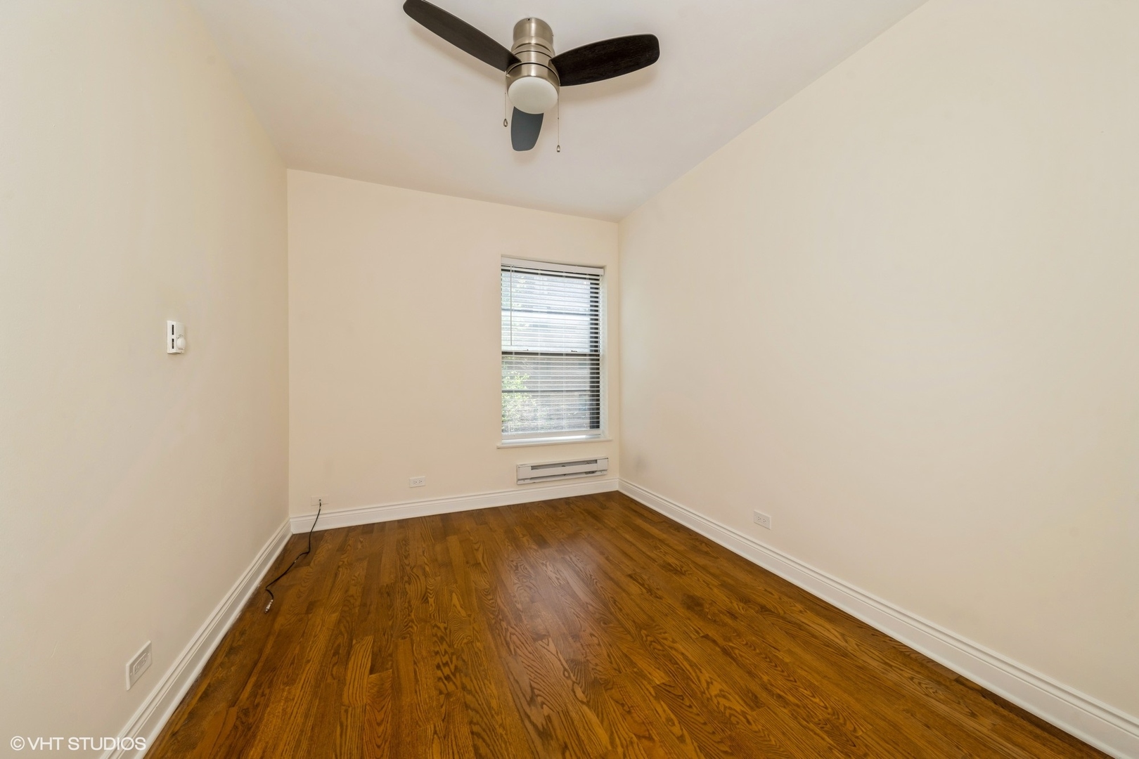1006 East 54th Street, Unit J2 Chicago, IL 60615 - Photo 14 of 15 an empty room with a window and a ceiling fan