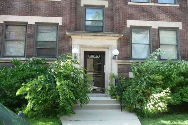 front view of a house with potted plants