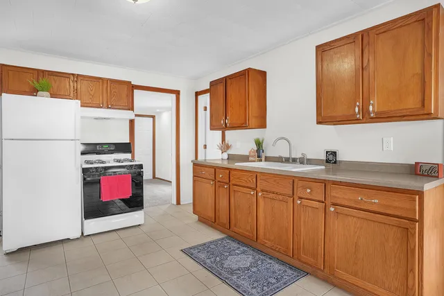 a kitchen with stainless steel appliances granite countertop a refrigerator sink and cabinets