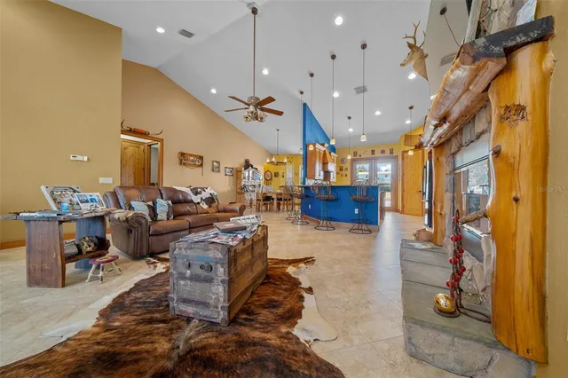 a living room with lots of furniture and kitchen view
