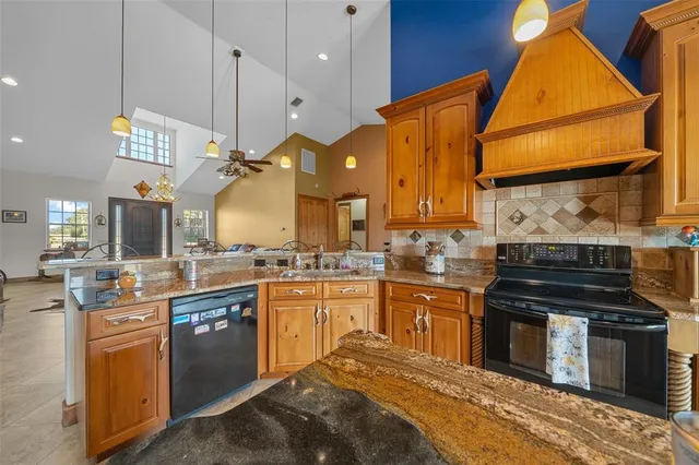 a kitchen with stainless steel appliances granite countertop a stove and a sink