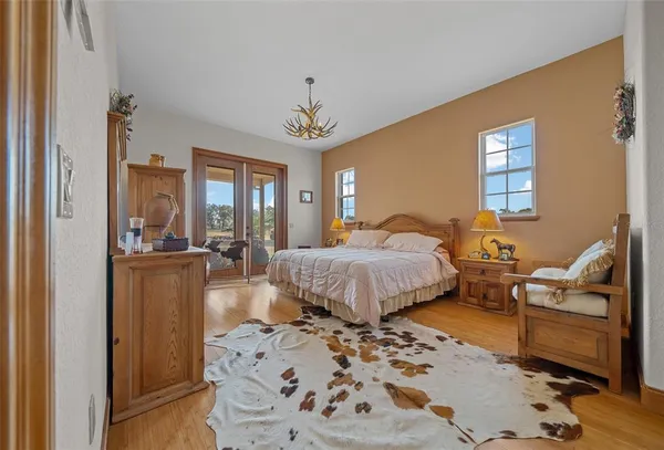 a bedroom with a bed and a chandelier