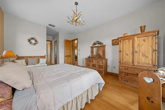a bedroom with a bed and a chandelier
