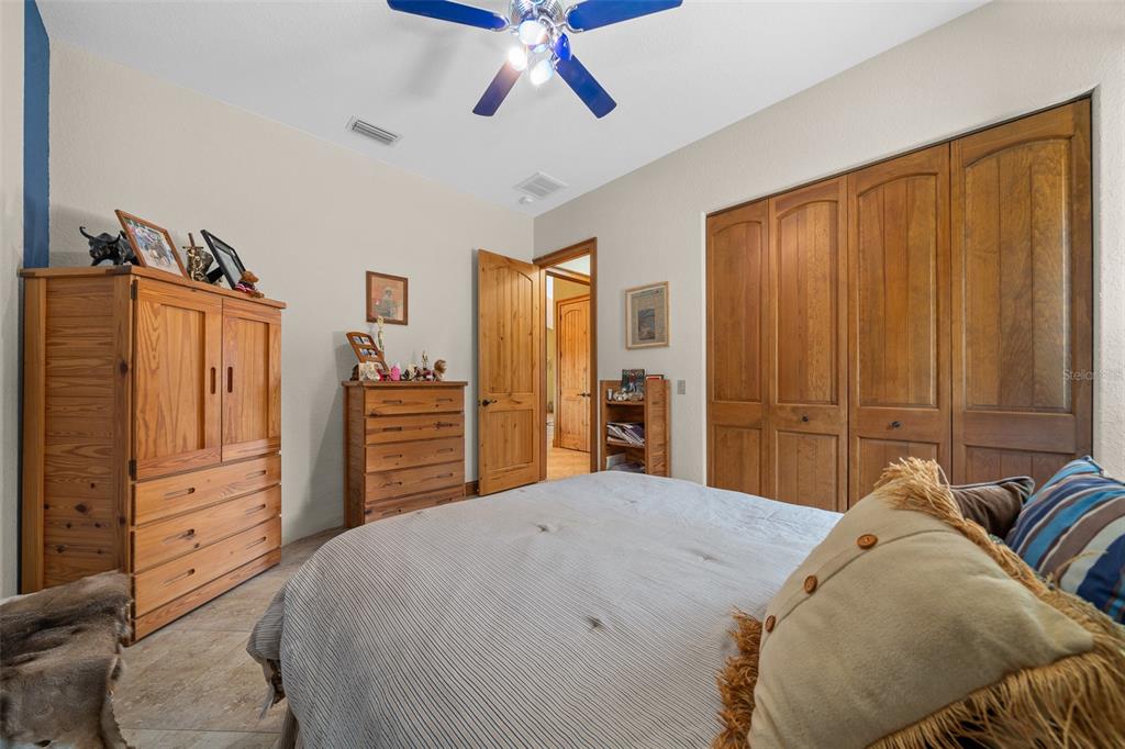 2198 West Highway 329 Citra, FL 32113 - Photo 26 of 57 a bedroom with a bed closet and flat tv screen
