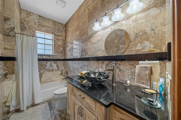 a bedroom with bed and a chandelier