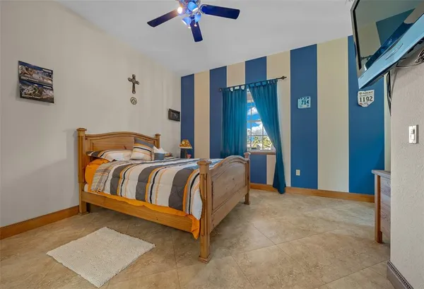 an empty room with closet and a ceiling fan