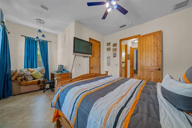 an empty room with closet and a ceiling fan