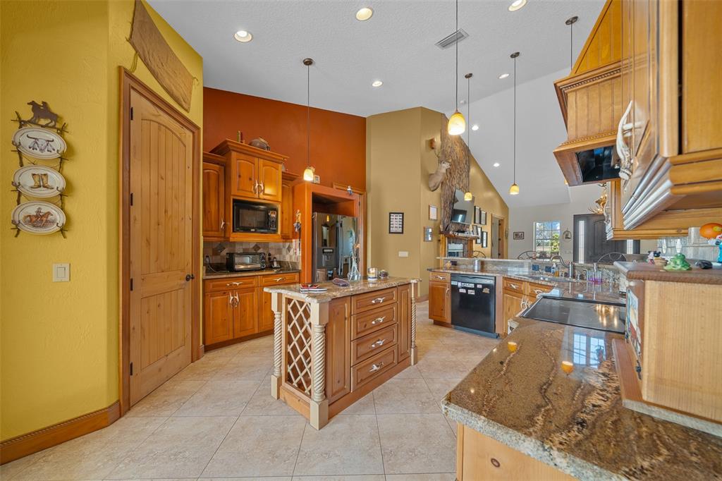 2198 West Highway 329 Citra, FL 32113 - Photo 35 of 57 a kitchen with stainless steel appliances granite countertop a refrigerator a oven and a sink