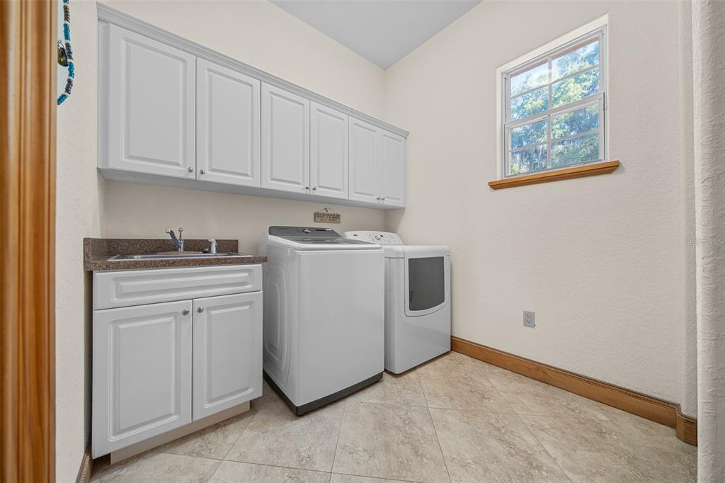 2198 West Highway 329 Citra, FL 32113 - Photo 37 of 57 a utility room with sink dryer and washer