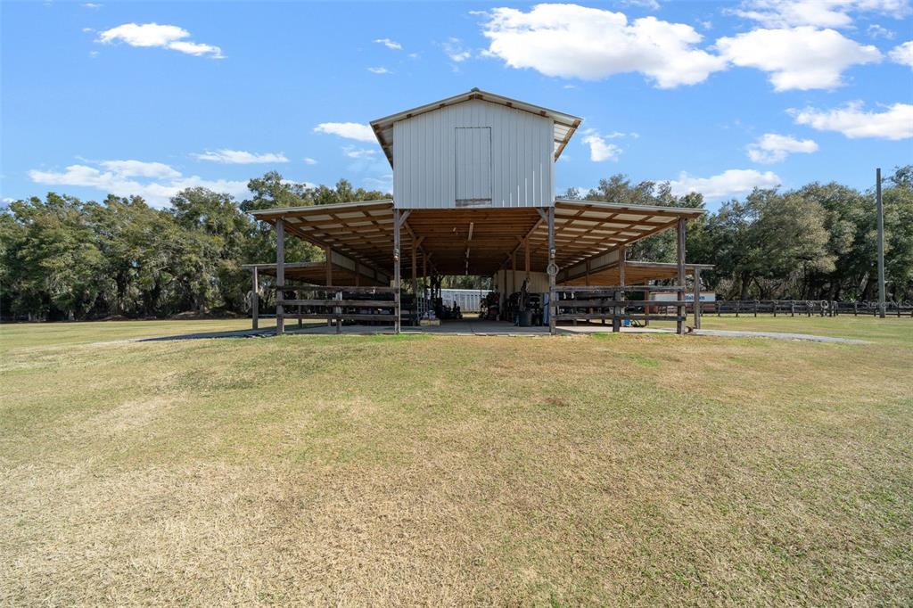 2198 West Highway 329 Citra, FL 32113 - Photo 41 of 57 a roof deck with table and chairs under an umbrella