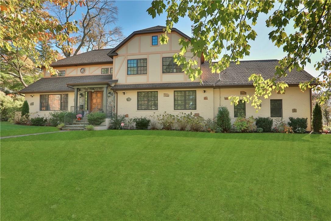 a front view of house with yard and green space