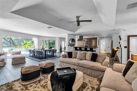 a large white kitchen with stainless steel appliances