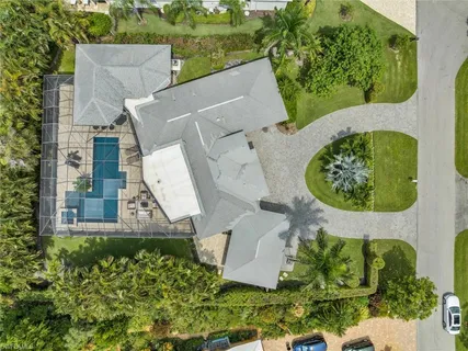 an aerial view of a house with garden space and street view