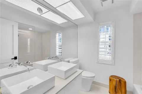 a bedroom with a bed lamp and a window