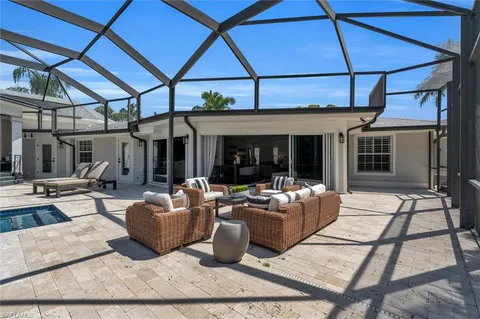 a building outdoor space with patio furniture and potted plants