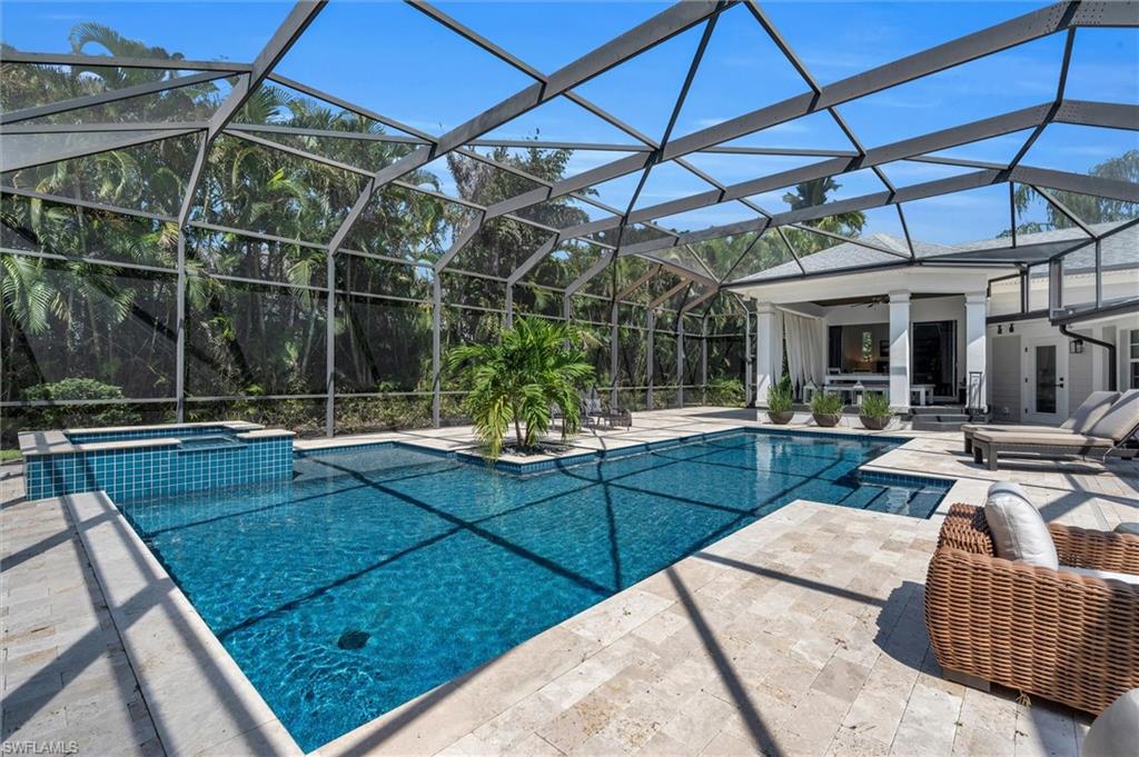 1627 Murex Lane Naples, FL 34102 - Photo 6 of 49 Combined pool / hot tub featuring a patio, glass enclosure, and a sunroom