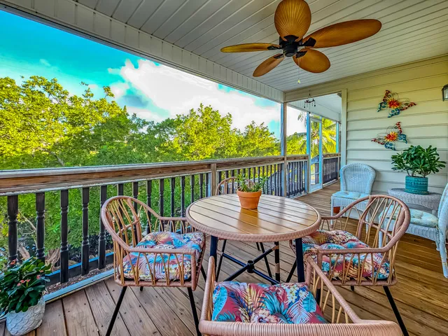 a view of a chairs and table in patio