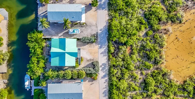 an aerial view of a house with a yard and garden