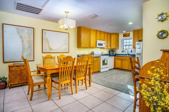 a large kitchen with a table and chairs