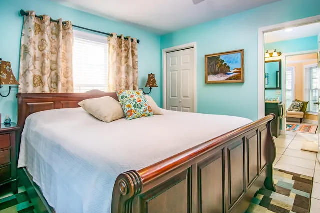 a bedroom with a bed and a window