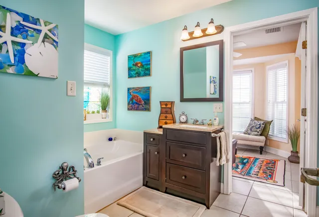 a bathroom with a tub sink and a mirror