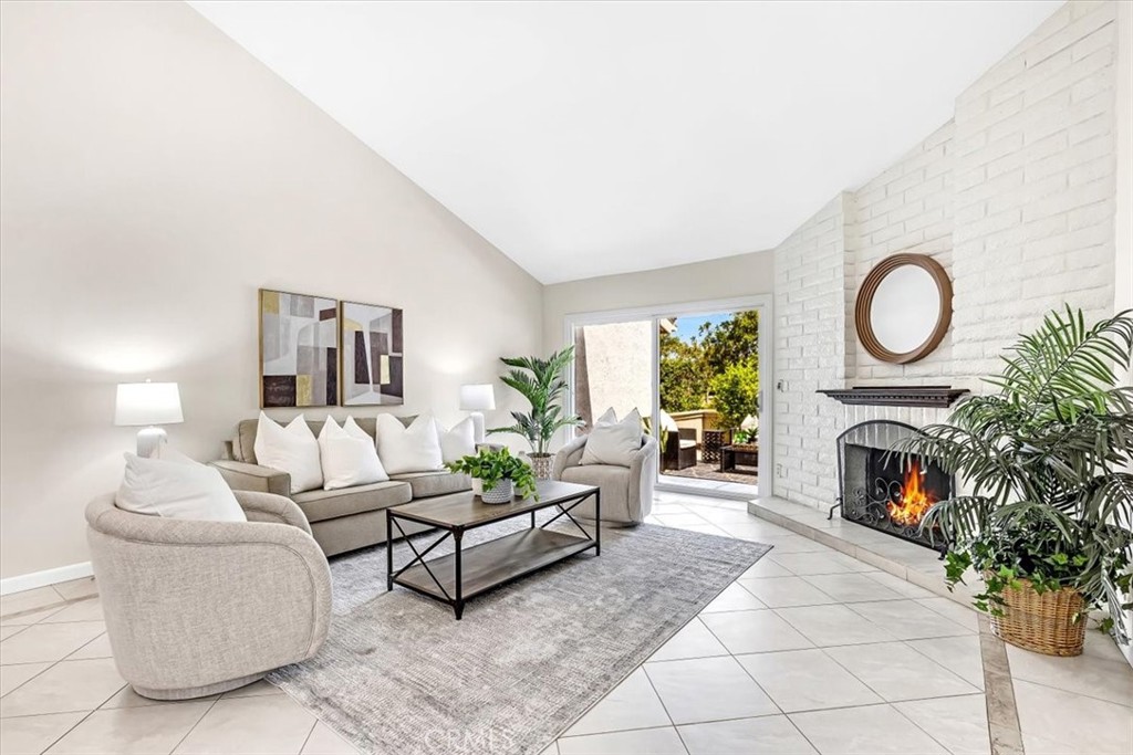 86 Sandpiper, Unit 17 Irvine, CA 92604 - Photo 1 of 56 a living room with furniture a fireplace and potted plants