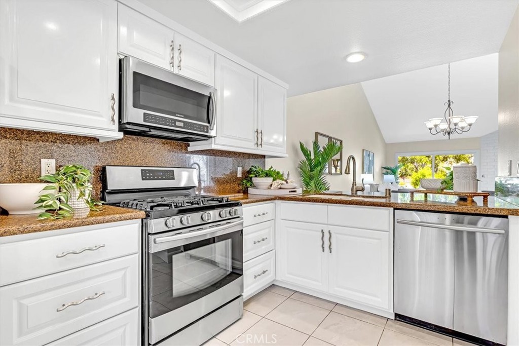 86 Sandpiper, Unit 17 Irvine, CA 92604 - Photo 11 of 56 a kitchen with white cabinets and appliances
