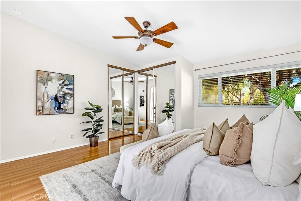 86 Sandpiper, Unit 17 Irvine, CA 92604 - Photo 16 of 56 a bedroom with a large bed and a large window