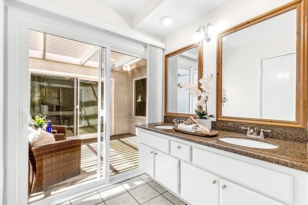 86 Sandpiper, Unit 17 Irvine, CA 92604 - Photo 18 of 56 a spacious bathroom with sinks mirror and a shower