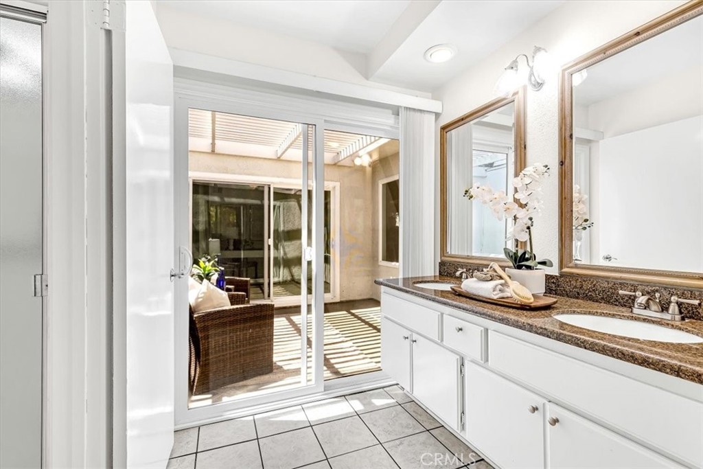 86 Sandpiper, Unit 17 Irvine, CA 92604 - Photo 19 of 56 a spacious bathroom with a mirror a sink and a shower