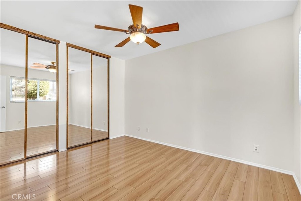 86 Sandpiper, Unit 17 Irvine, CA 92604 - Photo 27 of 56 a view of an empty room with wooden floor and a window