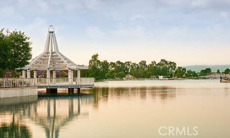 86 Sandpiper, Unit 17 Irvine, CA 92604 - Photo 49 of 56 a view of a lake with a house in the background