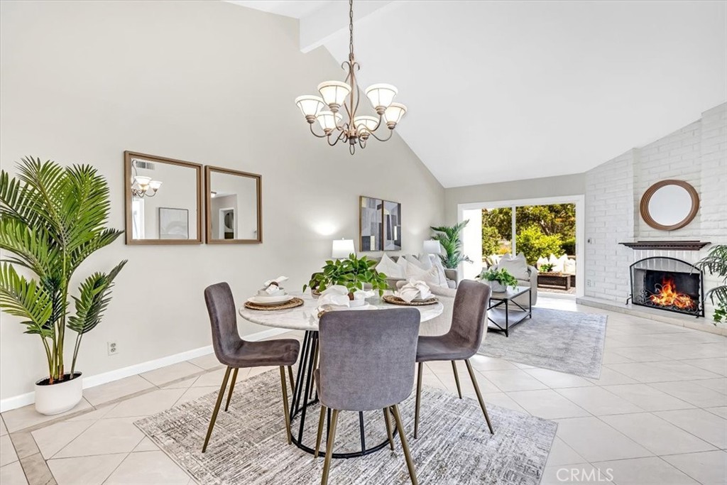86 Sandpiper, Unit 17 Irvine, CA 92604 - Photo 8 of 56 a view of a dining room with furniture and a fireplace