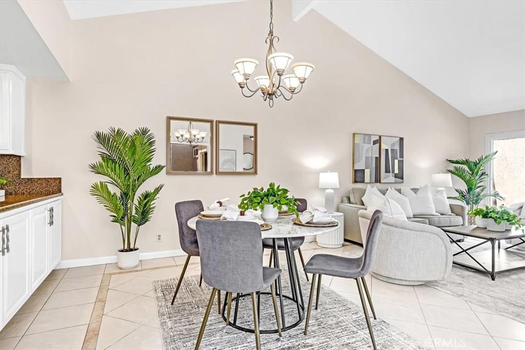 86 Sandpiper, Unit 17 Irvine, CA 92604 - Photo 9 of 56 a view of a dining room with furniture and a chandelier