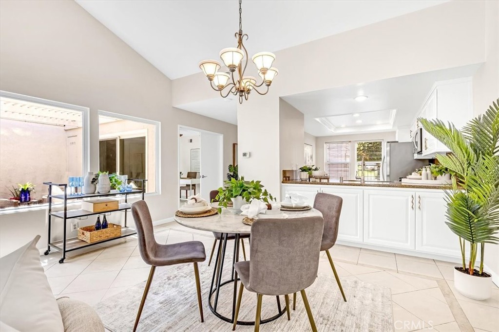 86 Sandpiper, Unit 17 Irvine, CA 92604 - Photo 10 of 56 a view of a dining room with furniture and a chandelier