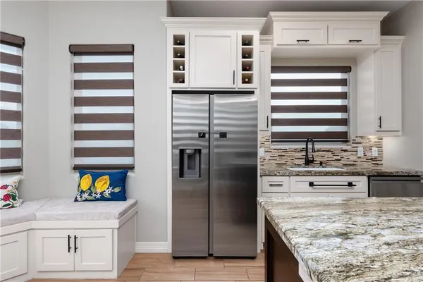 a kitchen with stainless steel appliances granite countertop a sink and dishwasher refrigerator oven