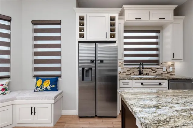 a kitchen with stainless steel appliances granite countertop a sink and dishwasher refrigerator oven