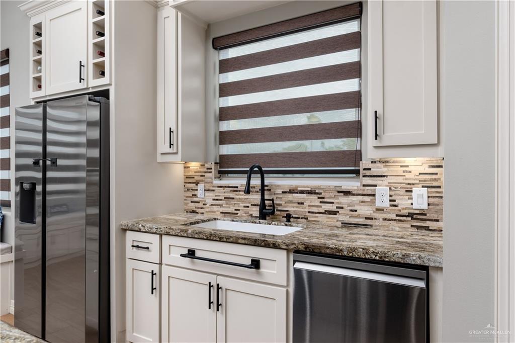 8405 Summer View Court Harlingen, TX 78552 - Photo 12 of 45 a kitchen with granite countertop cabinets stainless steel appliances and a sink