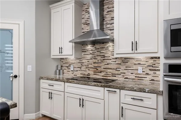 a kitchen with stainless steel appliances white cabinets and a sink