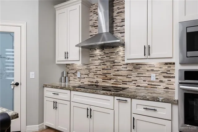 a kitchen with stainless steel appliances white cabinets and a sink