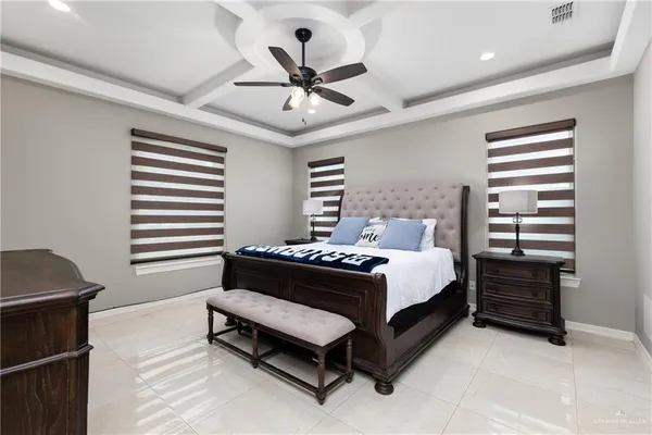 a bed room with a bed and a ceiling fan