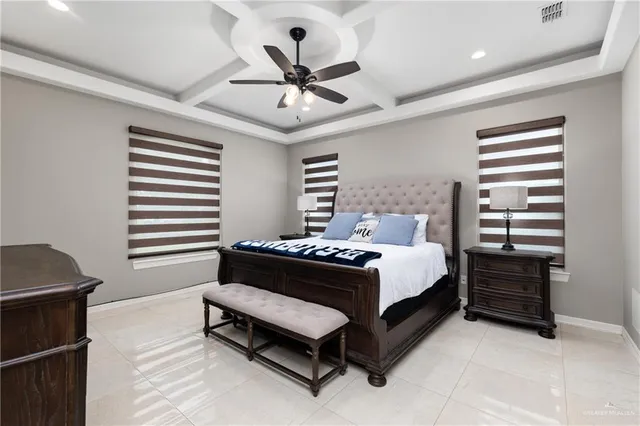 a bed room with a bed and a ceiling fan