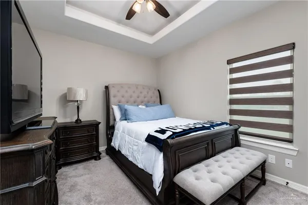 a bedroom with a bed and a television